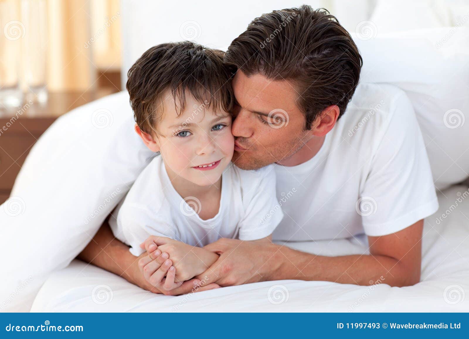 Father Kissing His Son Lying on Bed Stock Image Image of kids, play