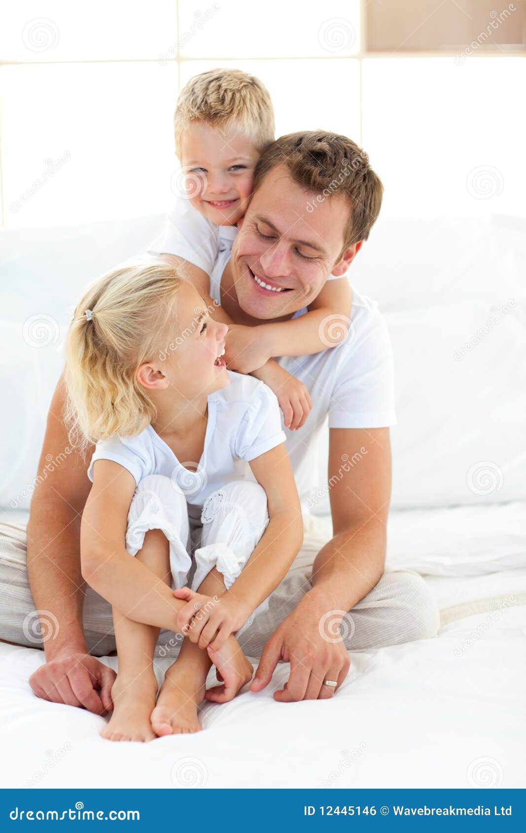 Father Playing With His Children On A Bed Royalty Free 