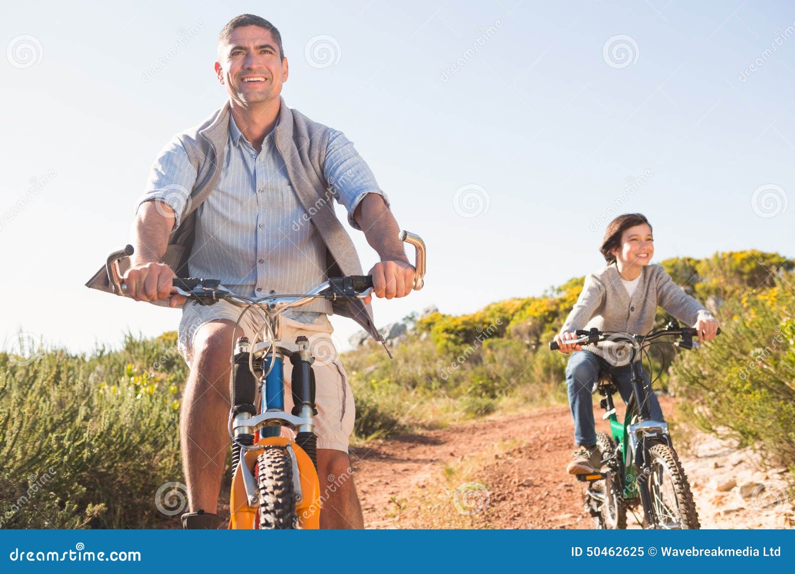 Father and son on a bike ride on a sunny day