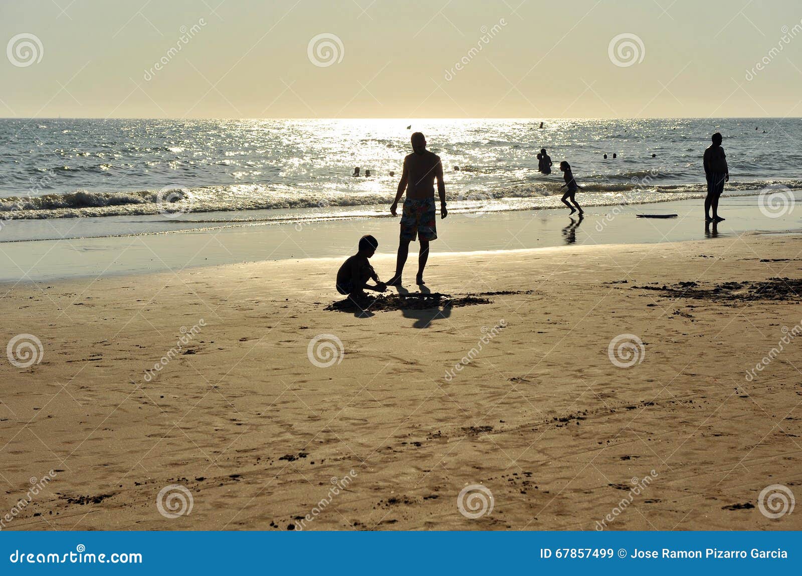 father and son on the costa ballena beach, cadiz province, spain