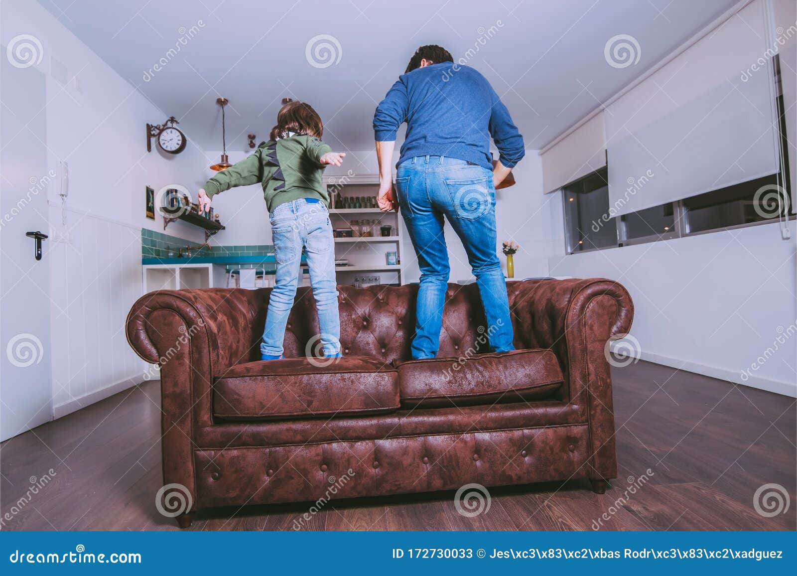 Father and Son Dancing on the Couch at Home. Father`s Day Concept Stock ...