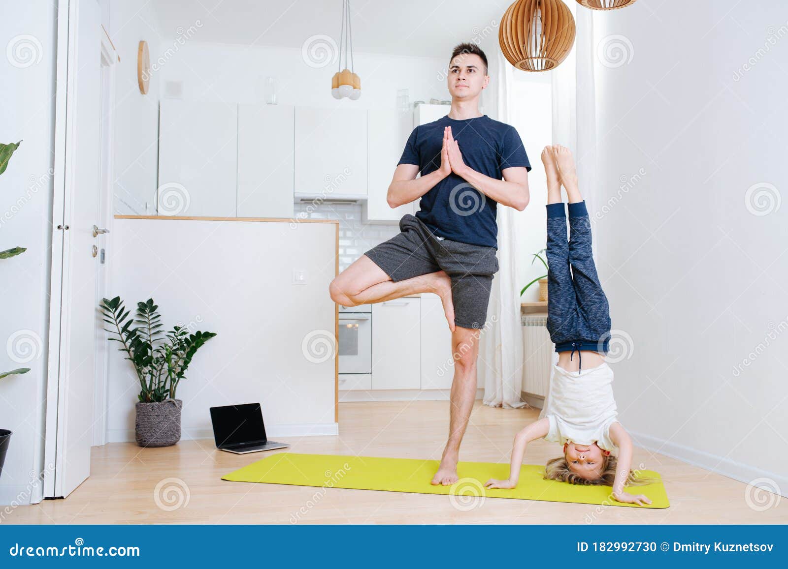 Father and Son Doing Yoga at Home on a Mat. Headstand and One Leg Stand  Stock Photo - Image of calm, lifestyle: 182992730