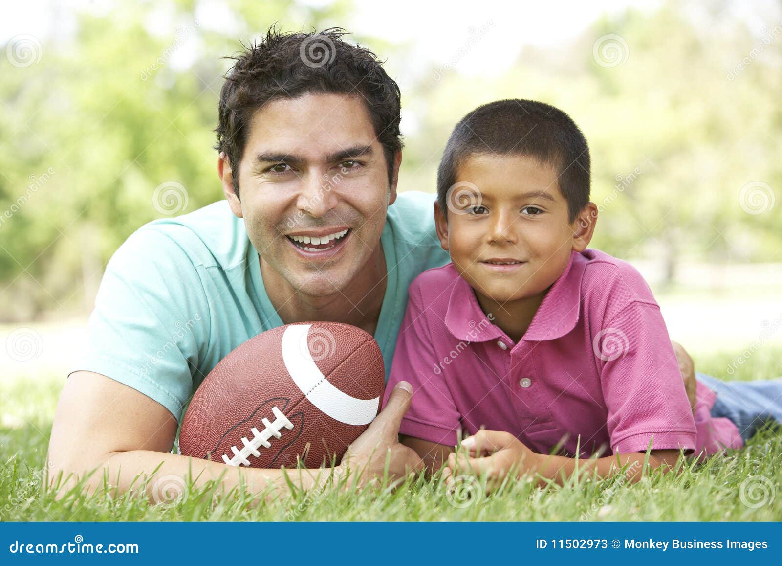 father and son in park with american football