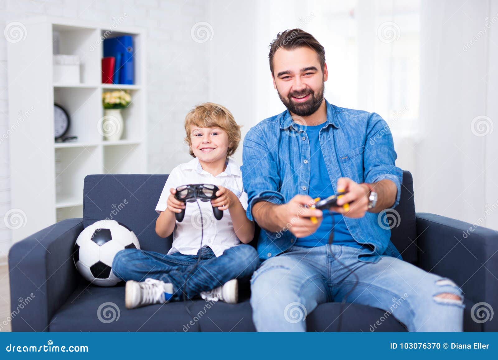 father and son playing video games