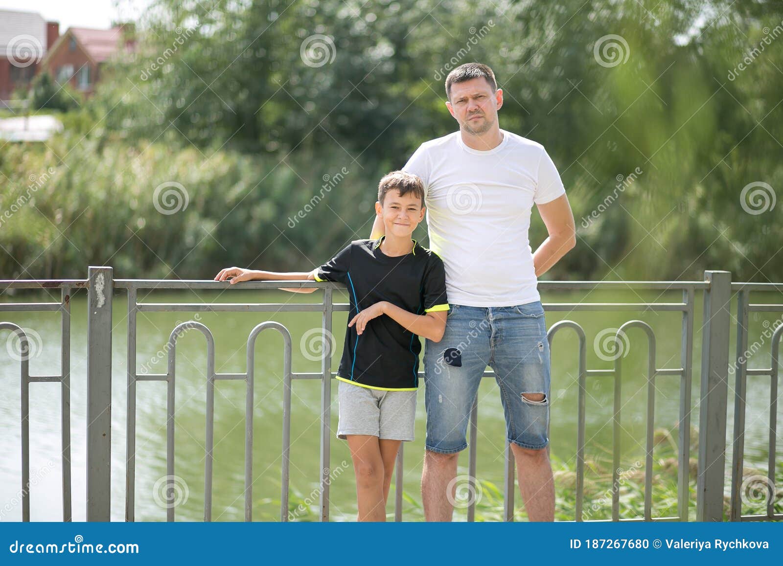 A Father and Son Teen Walk and Look in Camera Stock Photo - Image ...