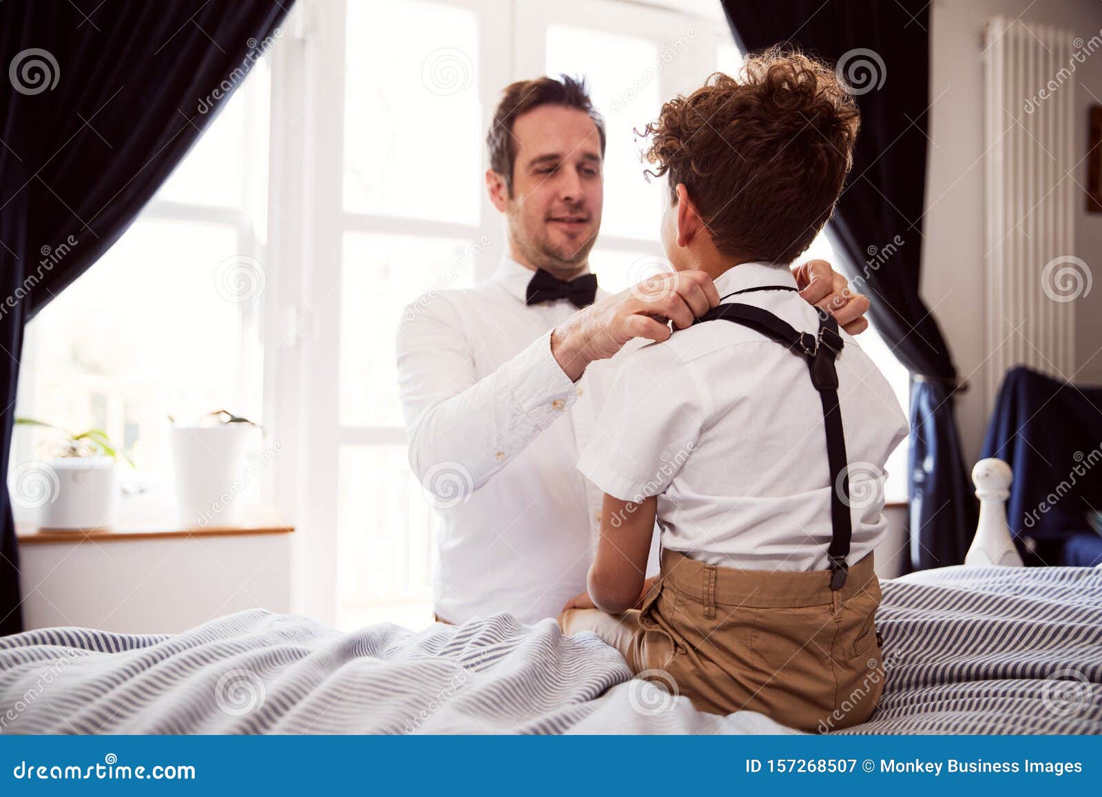 Father and Son Wearing Matching Outfits Getting Ready for Wedding at