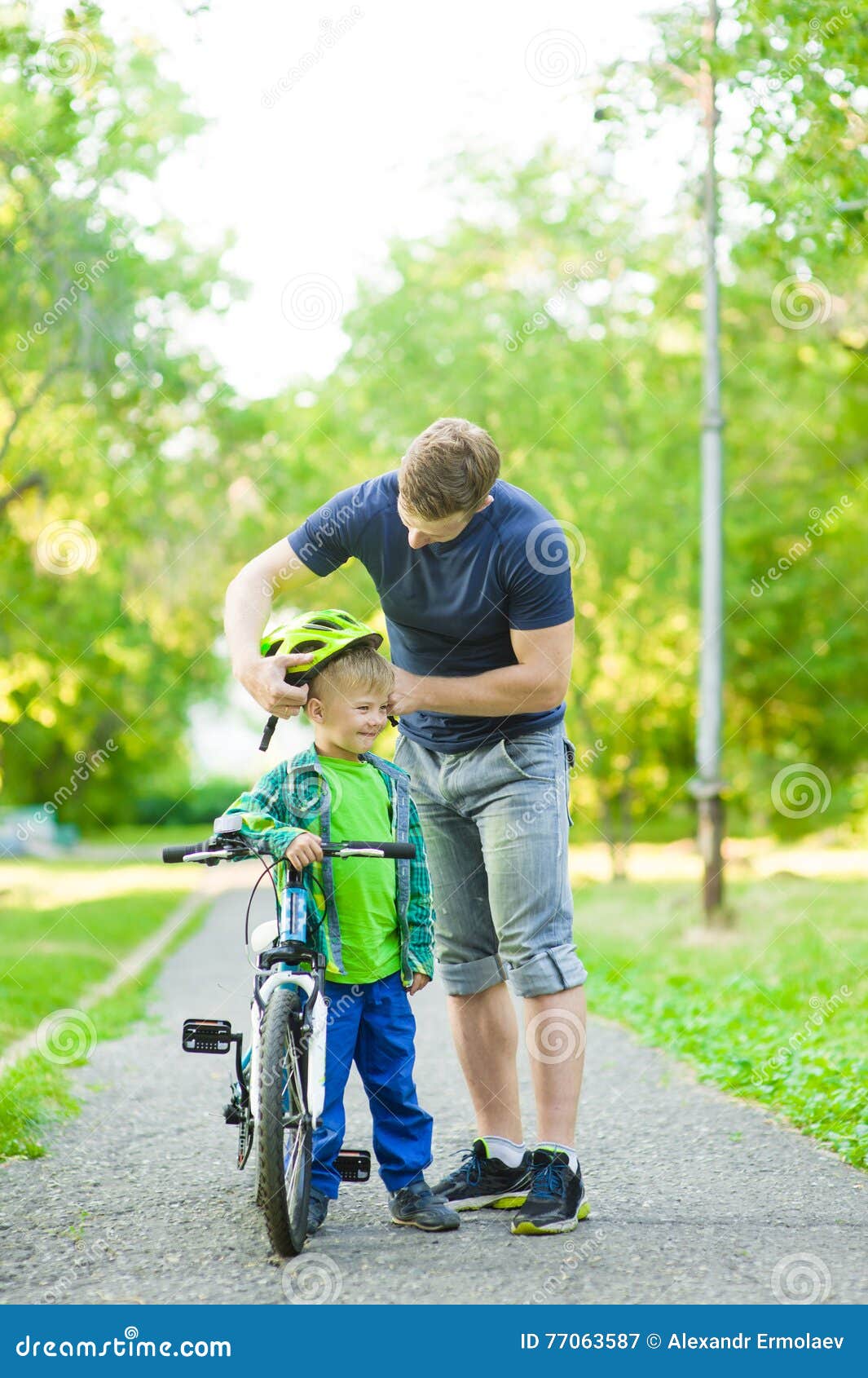 Father Wears a Protective Helmet To His Son Stock Image Image of