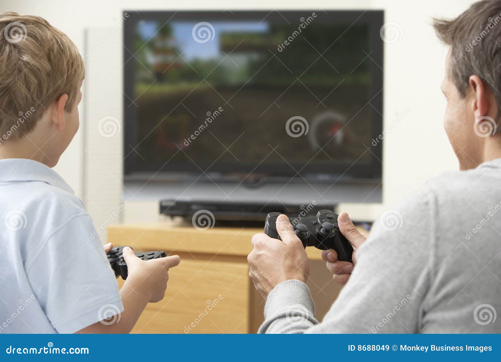 father and young son playing with game console