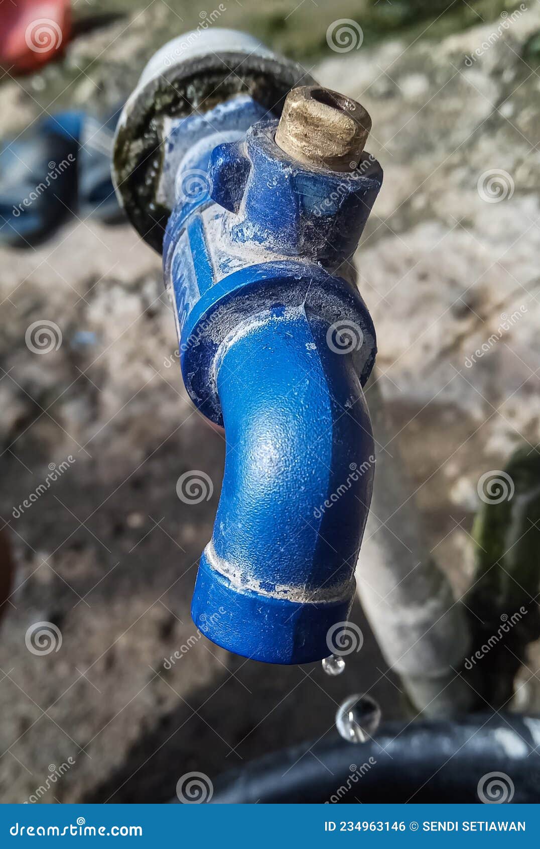Faucet in a Broken Housing with Water that Keeps Dripping Stock Photo