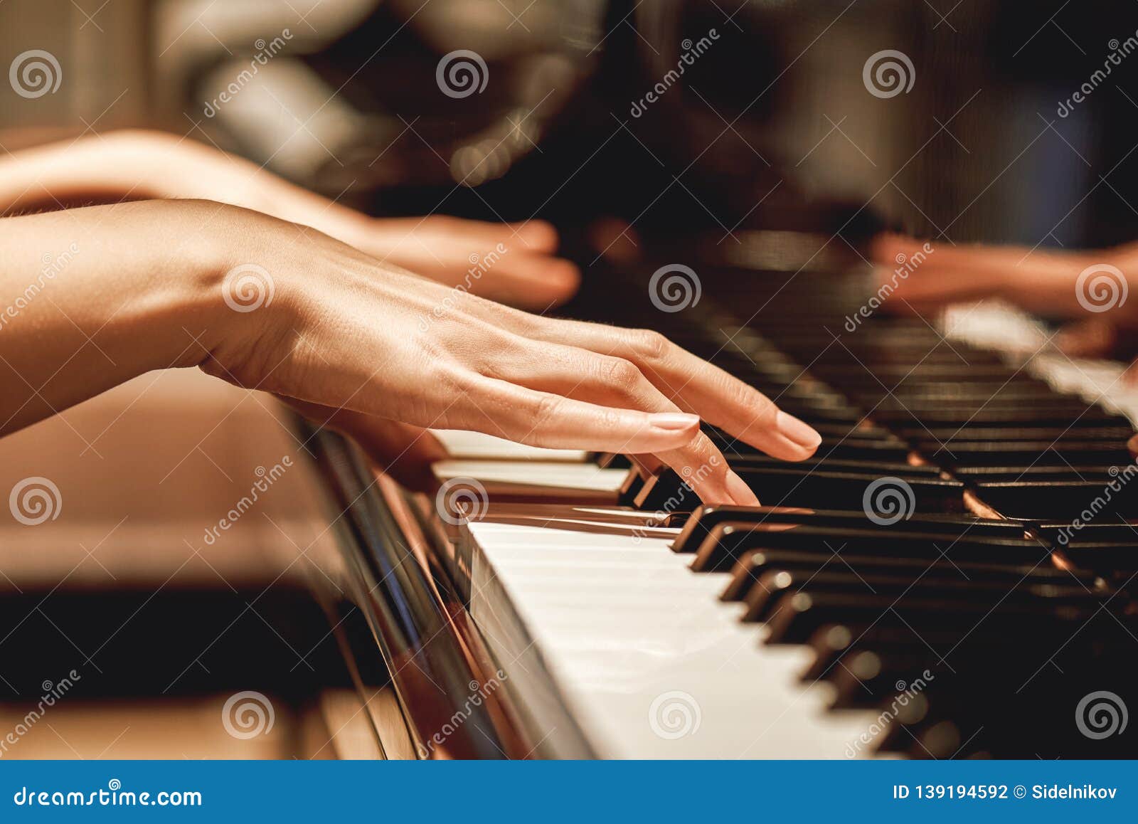 favorite classical music...close up view of gentle female hands playing a melody on piano while taking piano lessons