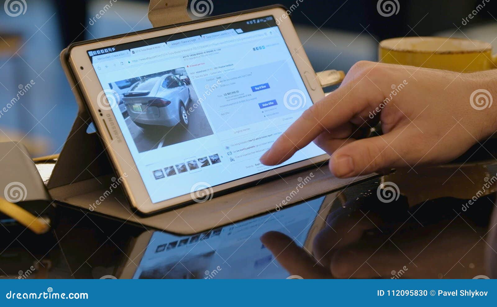 Man Exploring Ebay Site Looking For Used Tesla Car Using Tablet Pc In Cafe Stock Footage Video Of Internet Communication