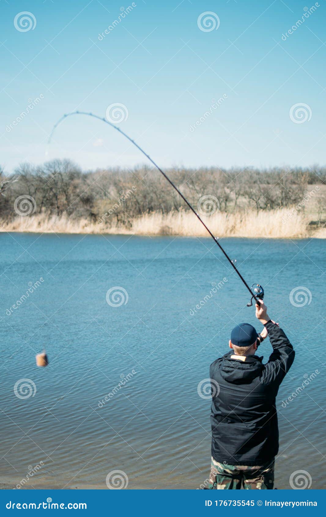 Feeder Fishing. Male Fisherman Fishing at Sun Day on the Lake. Man