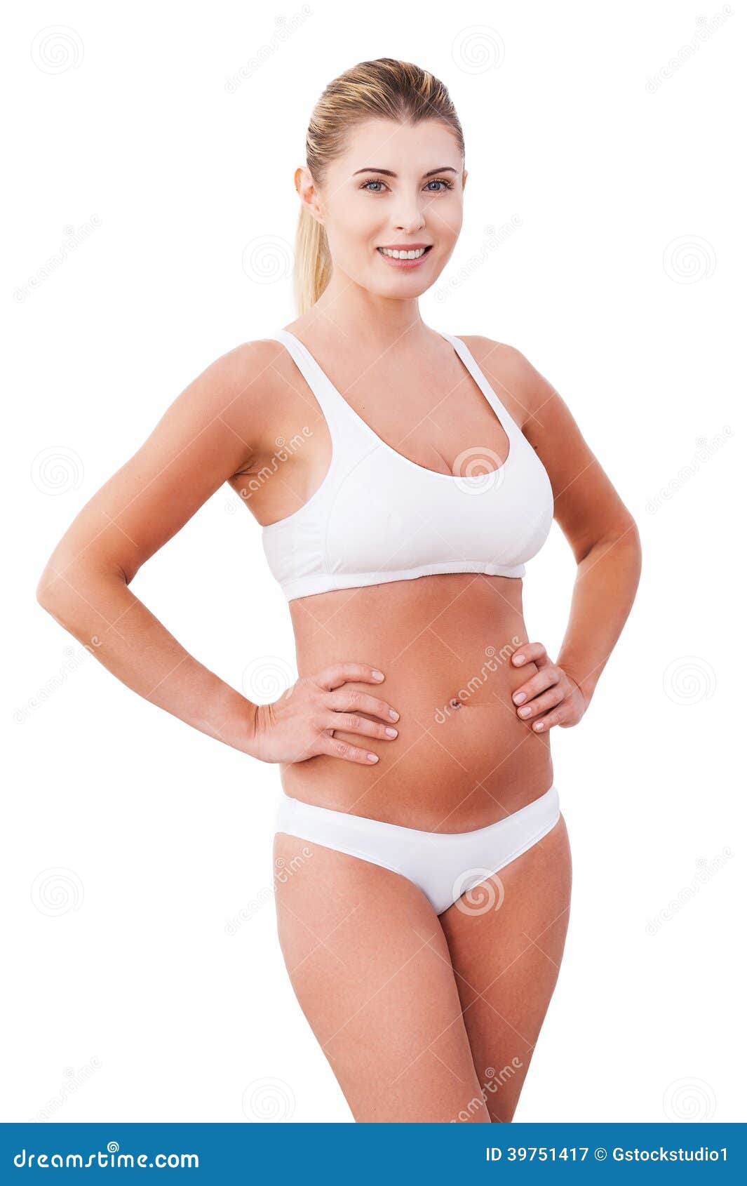 Middle-aged woman posing wearing a blue t-shirt and panties stock photo