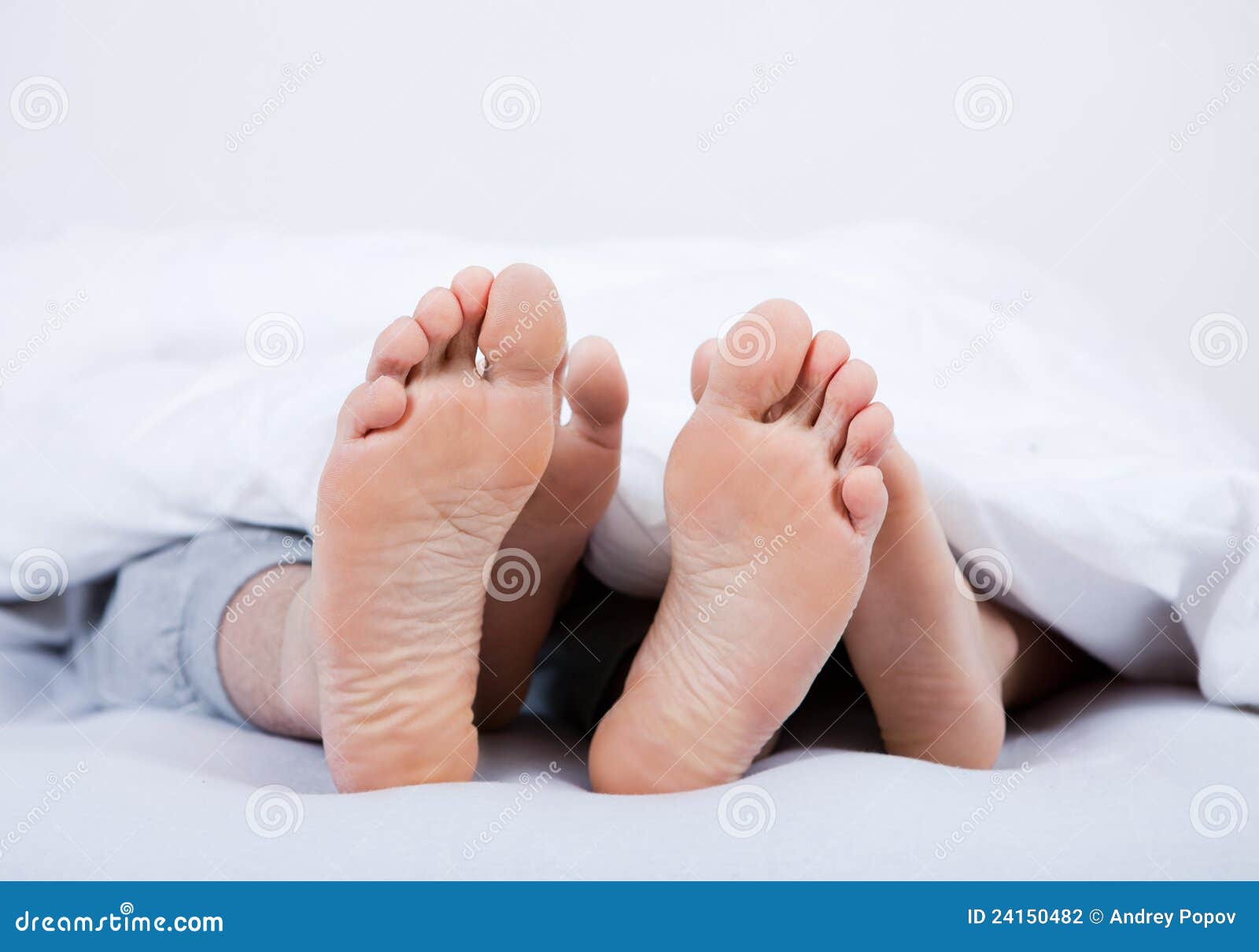 Feet of a Couple Under the Blanket Stock Photo Image of indoors