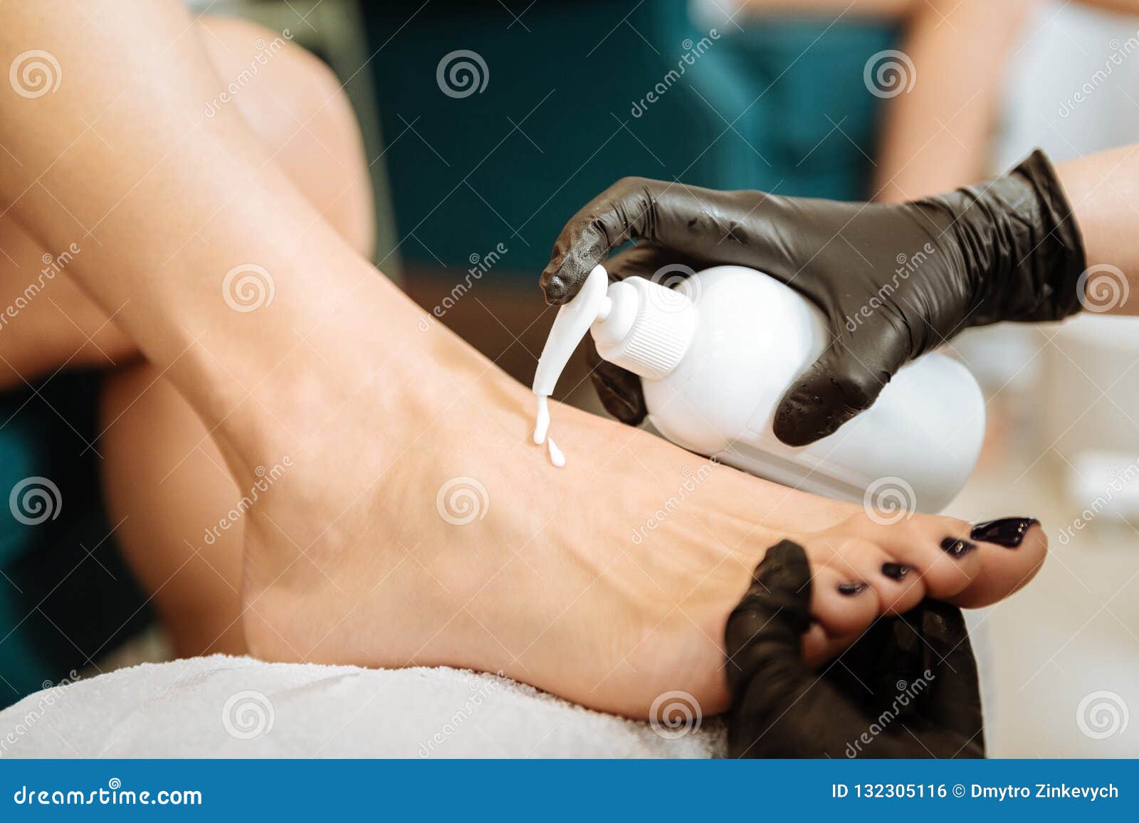 professional chiropodist using some moisturizing feet cream