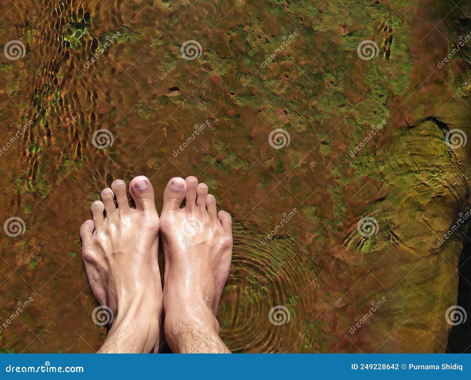 The Feet of a Man Standing on a Rock Running Hot Water. Stock Photo ...