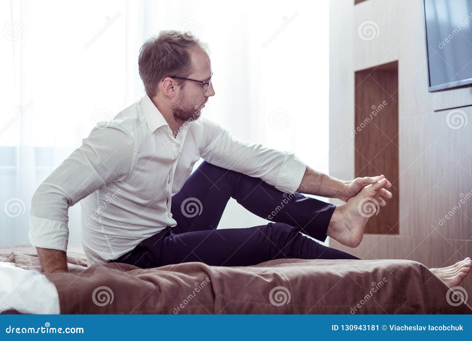 Tired Businessman Making Feet Massage After All Day Working Stock Image