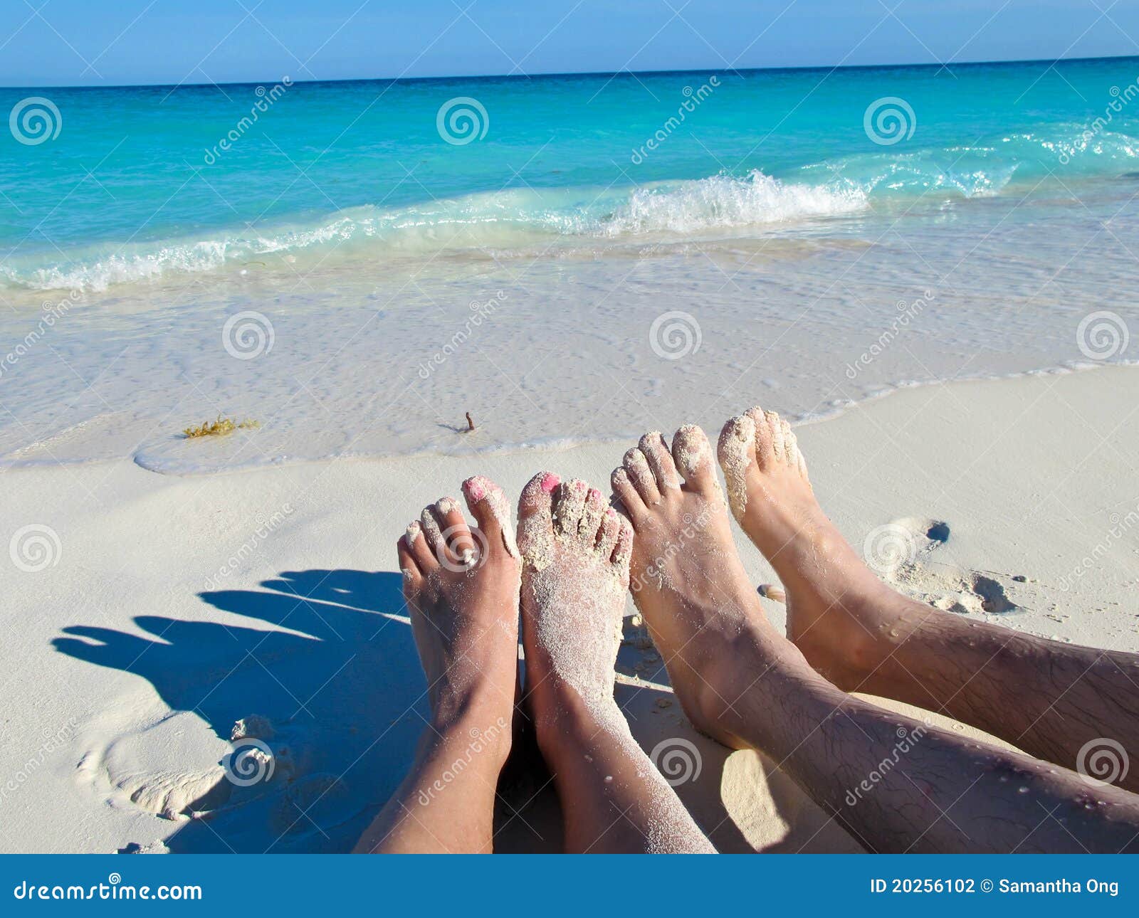 feet in the sand at playa blanca, cayo largo, cuba