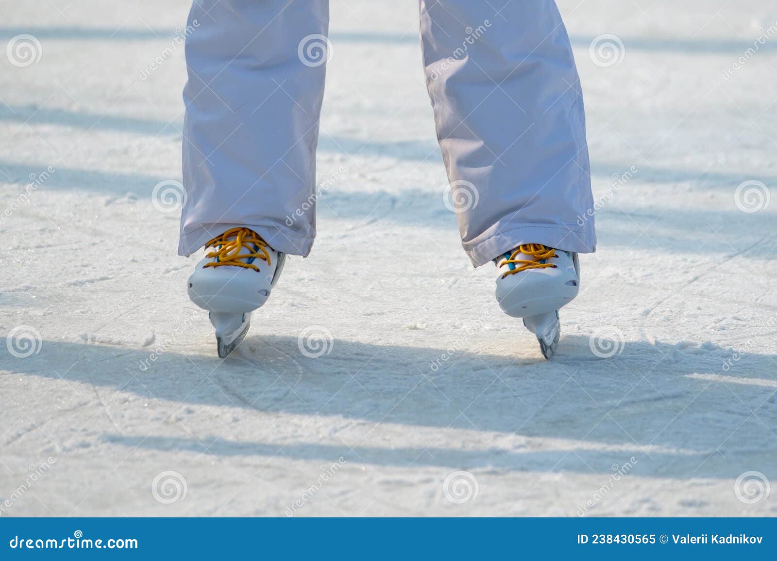 Feet in the skates on ice stock image. Image of rink 238430565