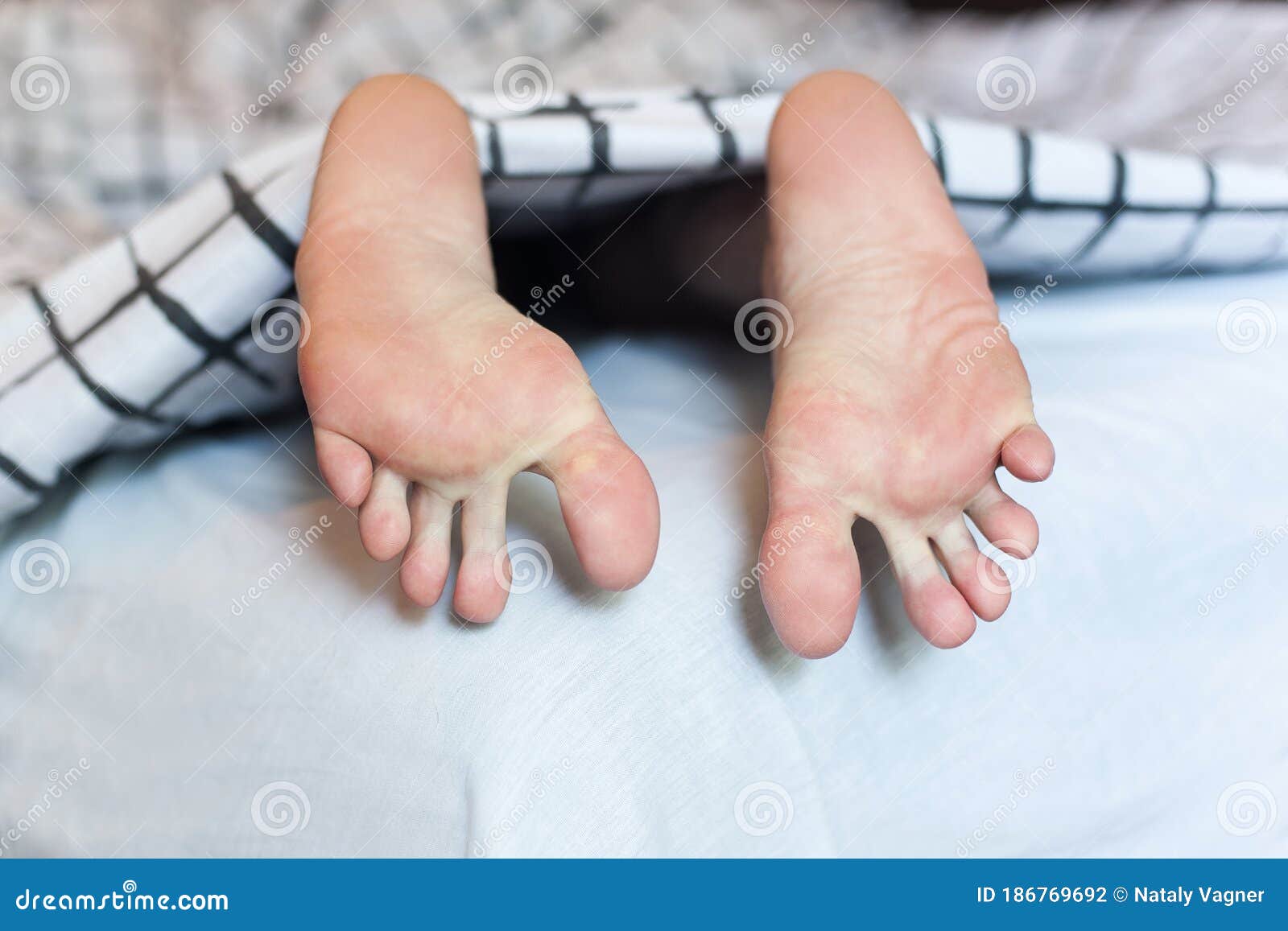Feet Sticking Out from Under the Covers Stock Photo Image of spread