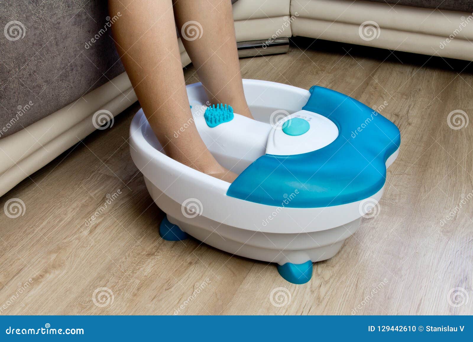 Feet in a Vibrating Foot Massager. Electric Massage Bath Stock Photo