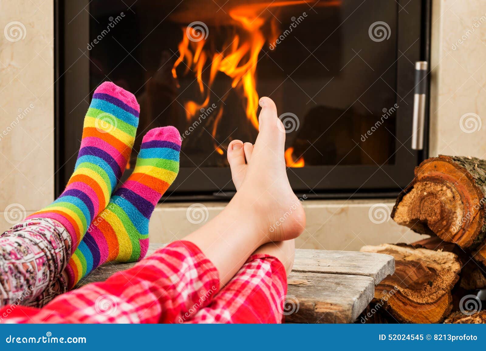 Feet warming by fireplace stock image. Image of people 52024545