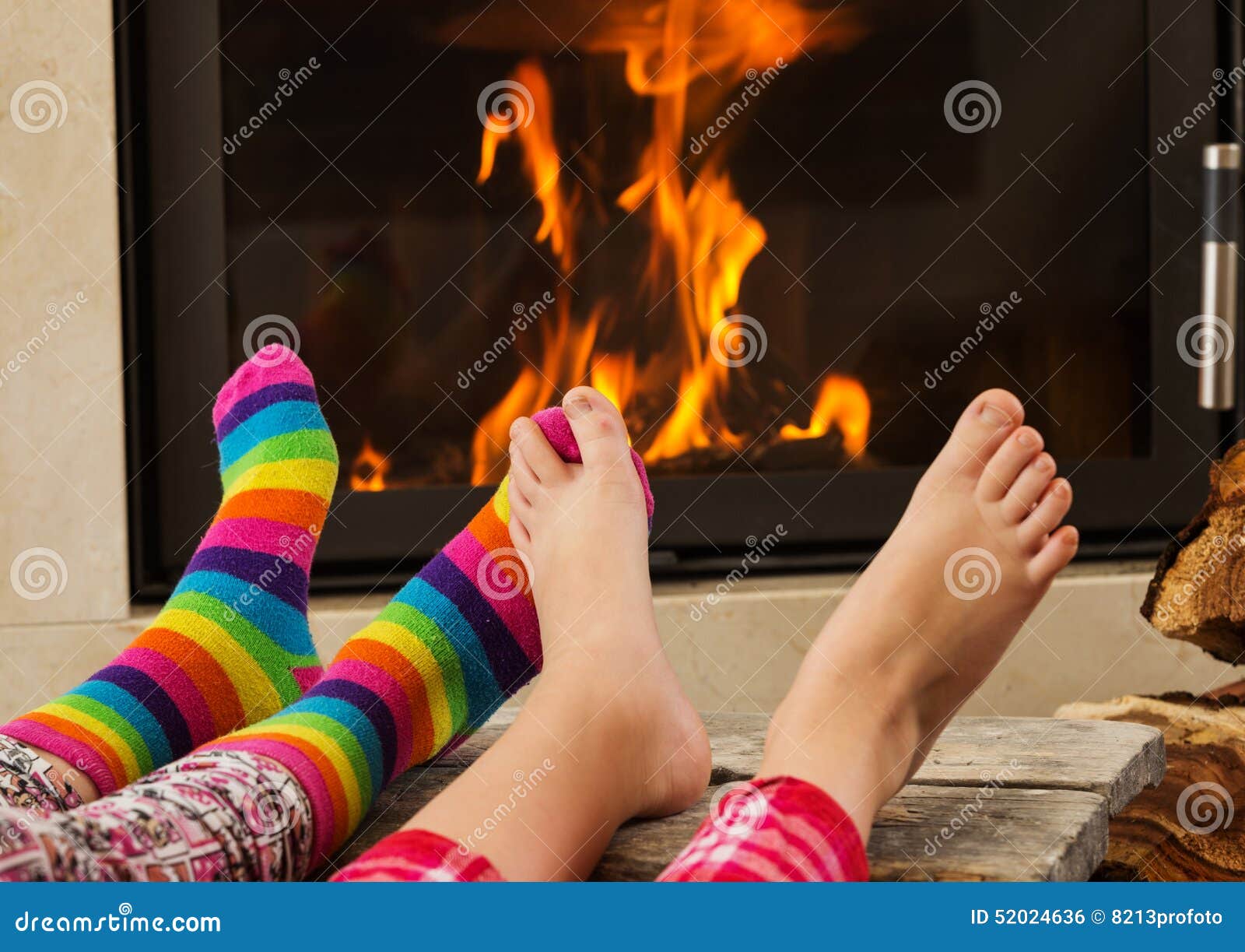 Feet warming by fireplace stock photo. Image of foot 52024636