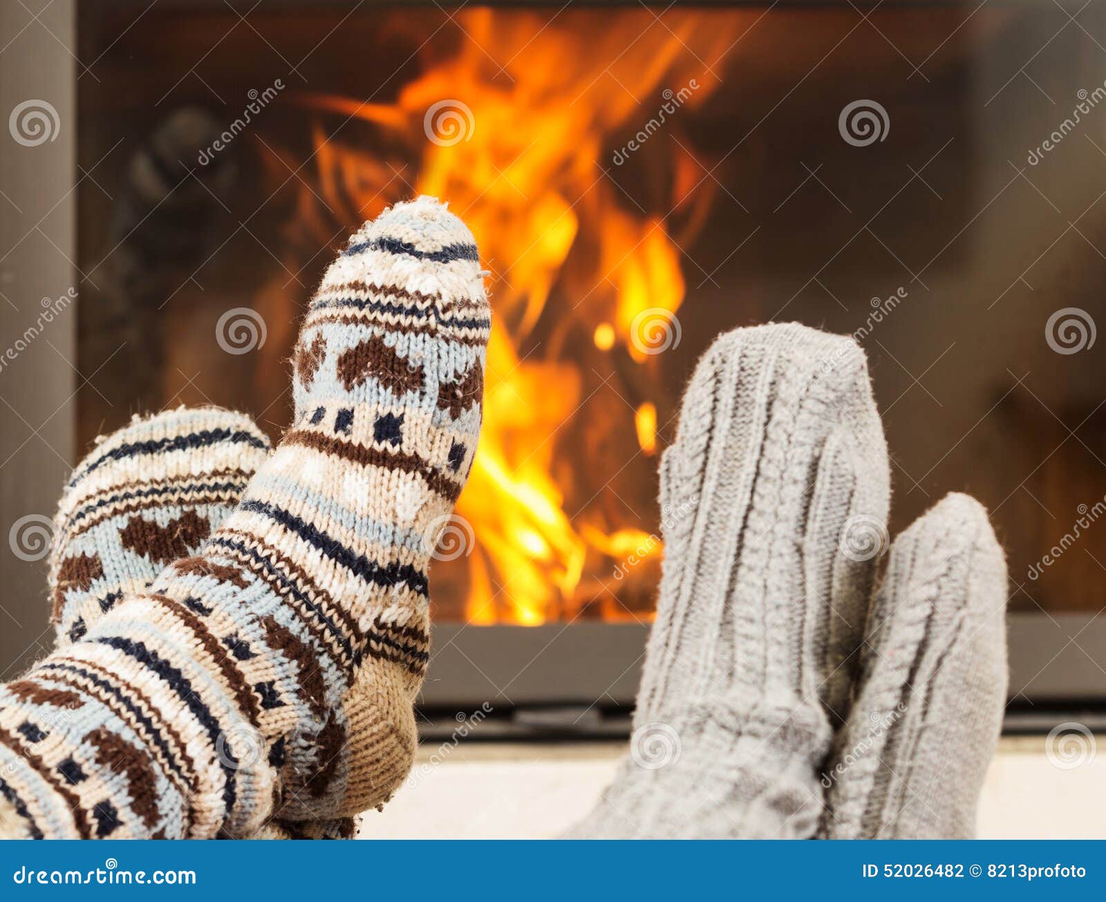 Feet warming by fireplace stock photo. Image of pairs 52026482