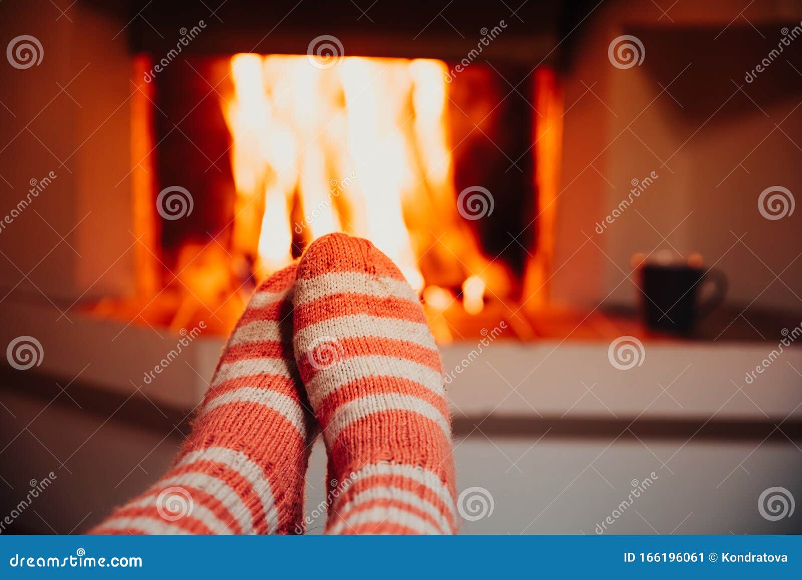 Feet in Wool Striped Socks by the Fireplace. Relaxing at Christmas ...