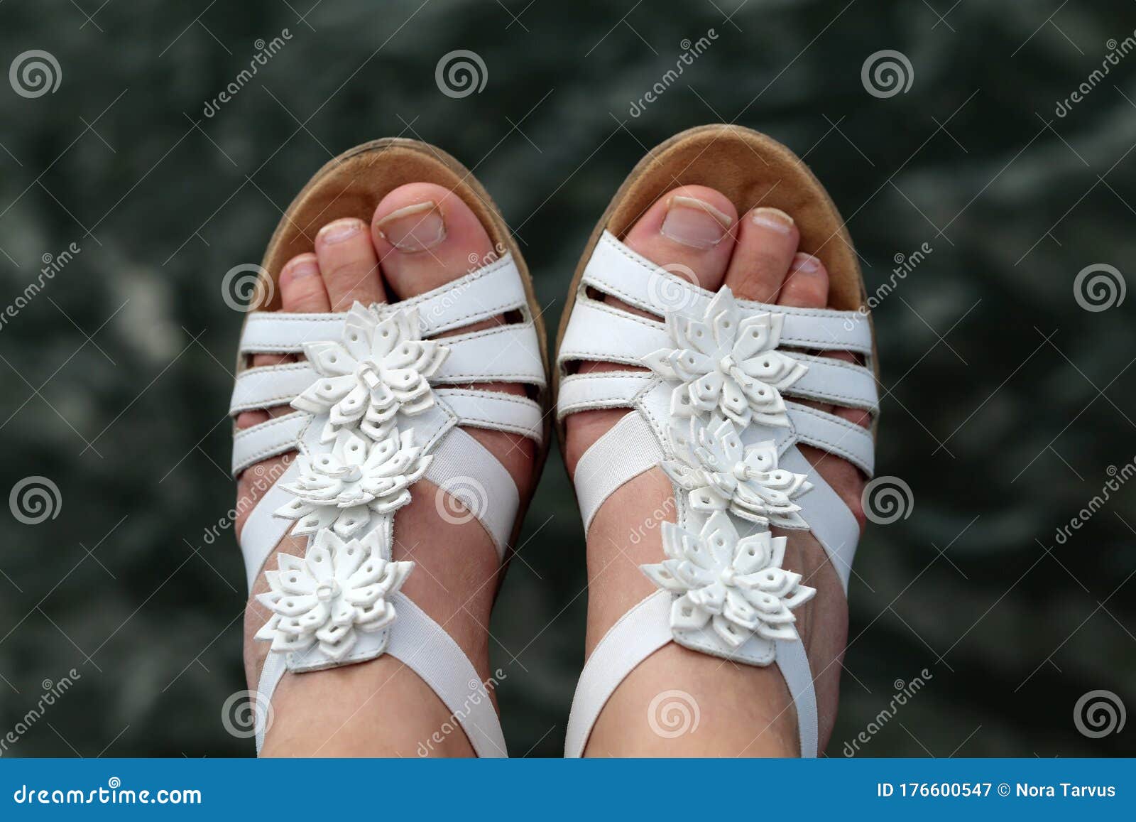Caucasian Woman Wearing White Leather Strap Sandals with Flower Decor, Feet  in a Closeup Stock Image - Image of beauty, girl: 176600547