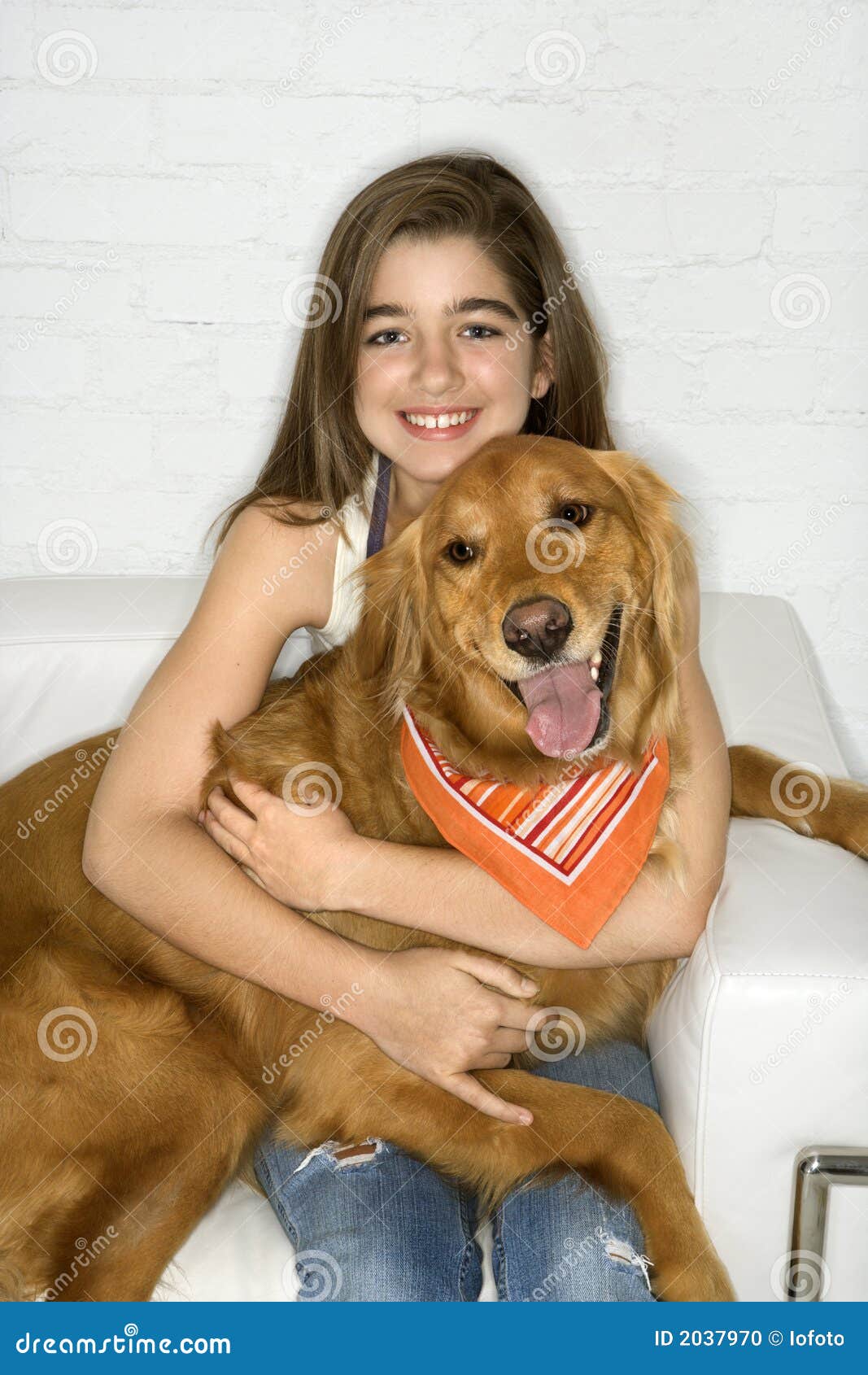 female adolescent holding dog.