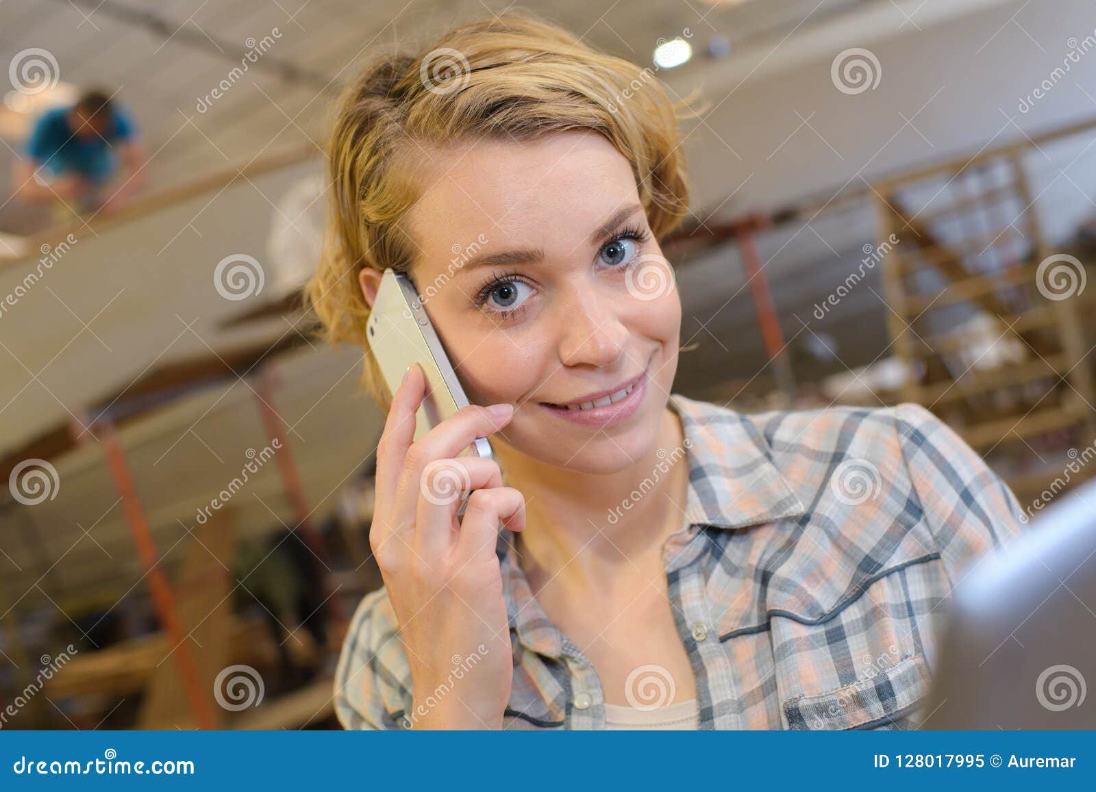 Female Artist Smiling and Talking on Mobile Phone in Stock