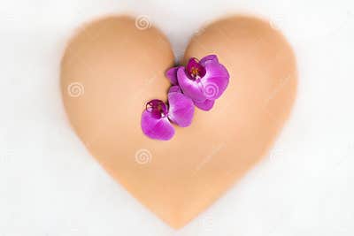 Female Booty in Shape of a Heart with Orchid Stock Image - Image of