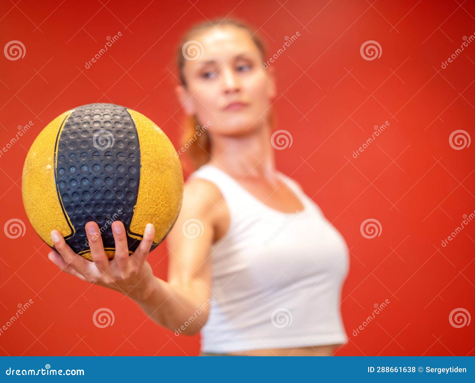 Female Sports Coach in Sportswear Holding a Ball on Red Isolated ...