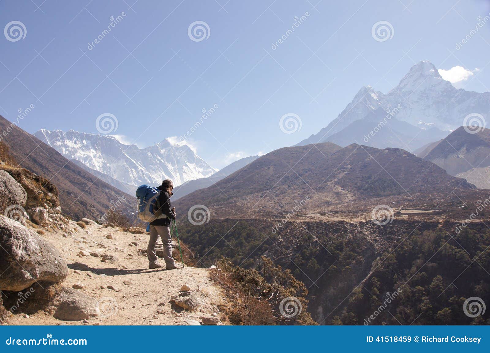 female backpacker hikes trail