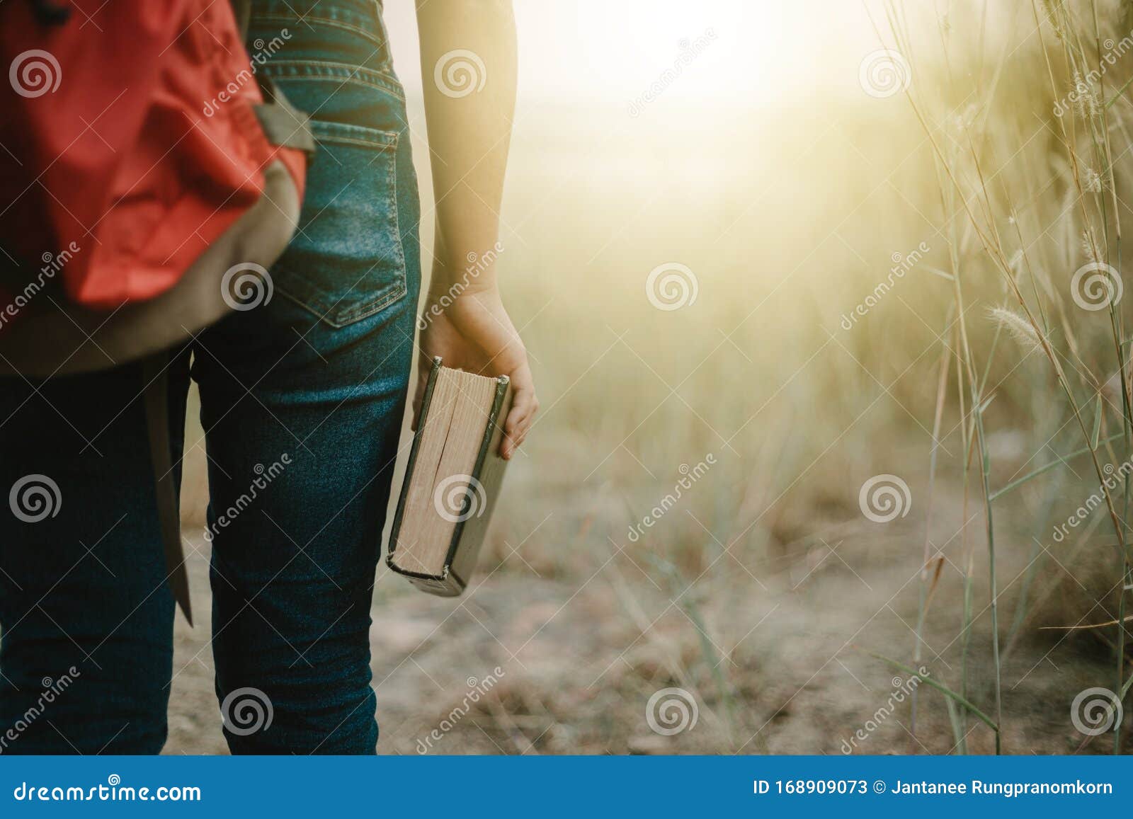 female backpackers standing and hold the bible.