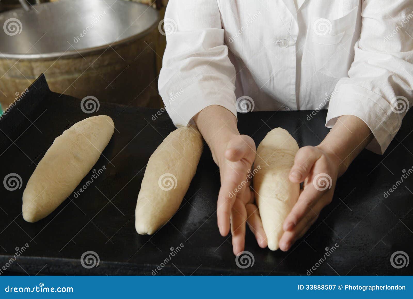 female baker shaping loaves