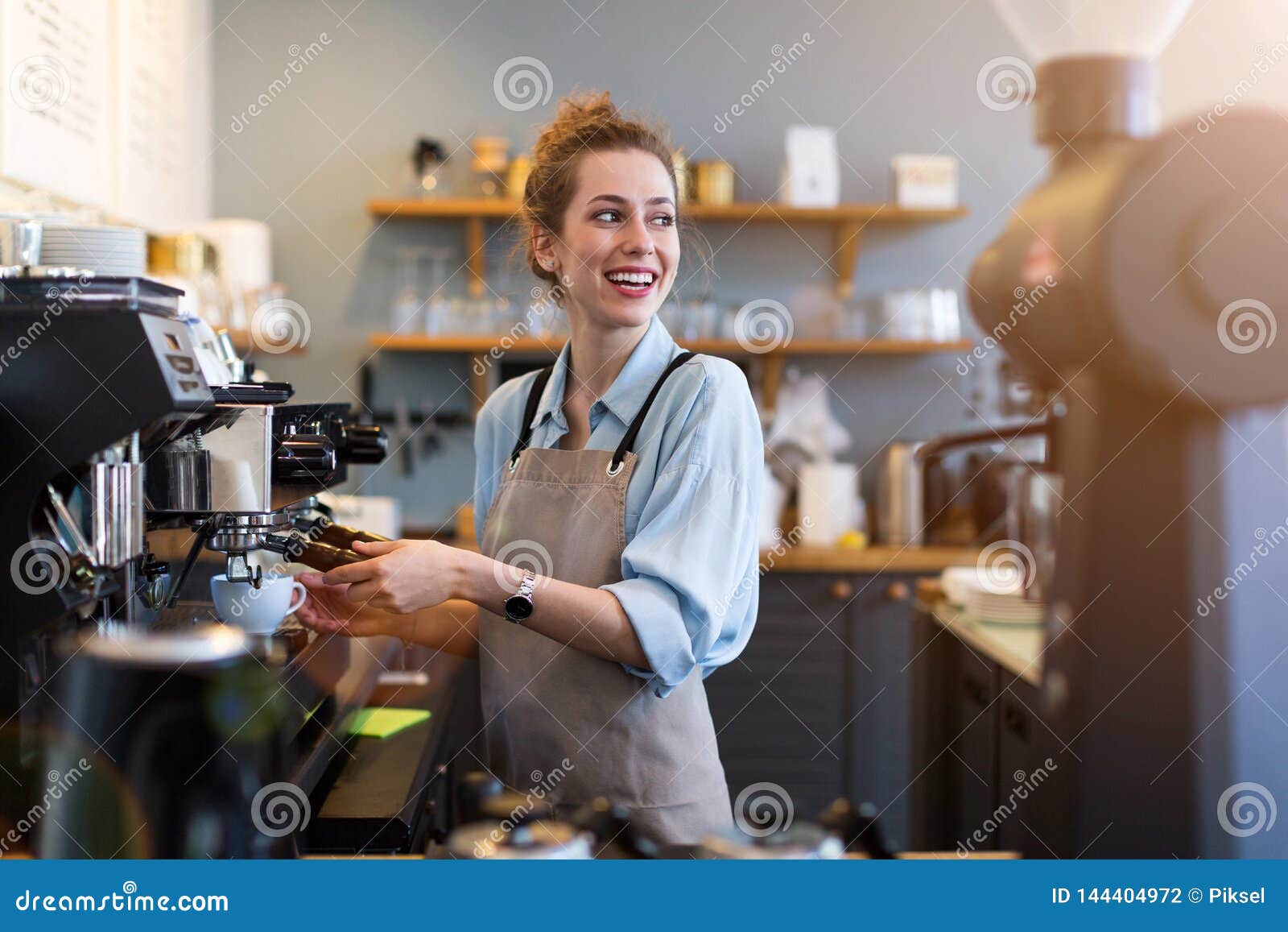 female barista making coffee