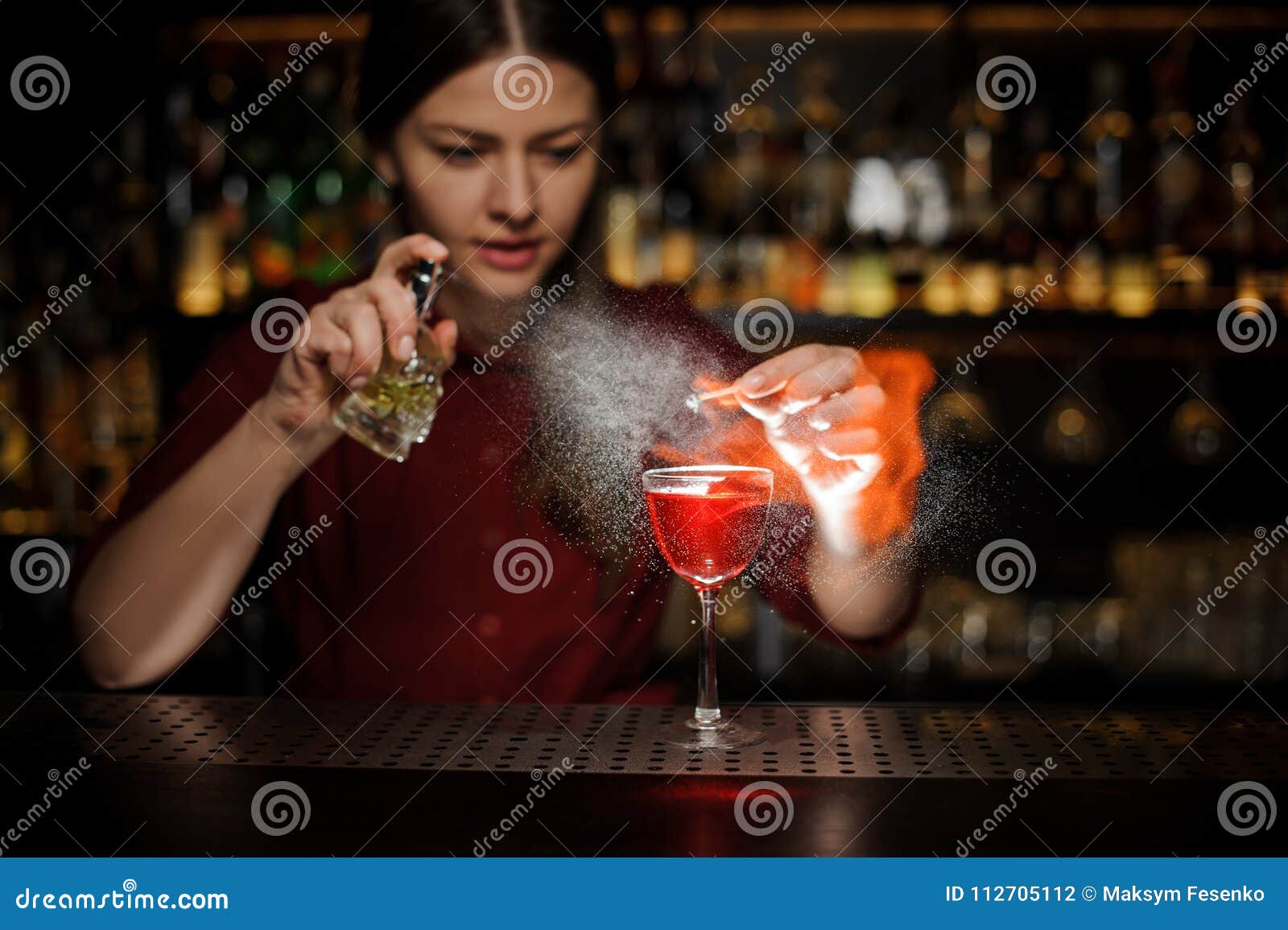 Female Bartender Sprinkling a Cocktail Glass with Aperol Syringe ...