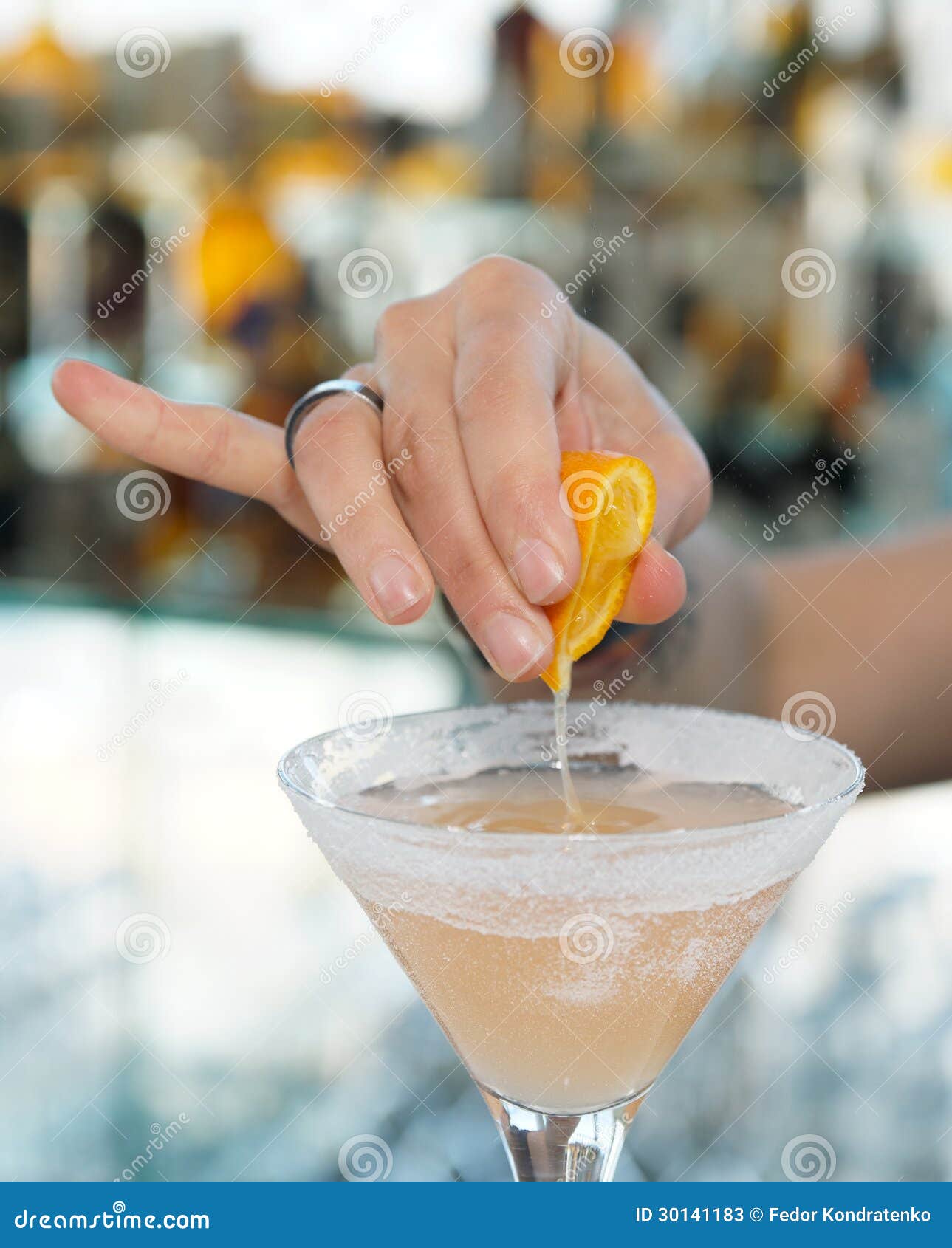 Female Bartender is Squeezing Orange Juice into Glass Stock Image