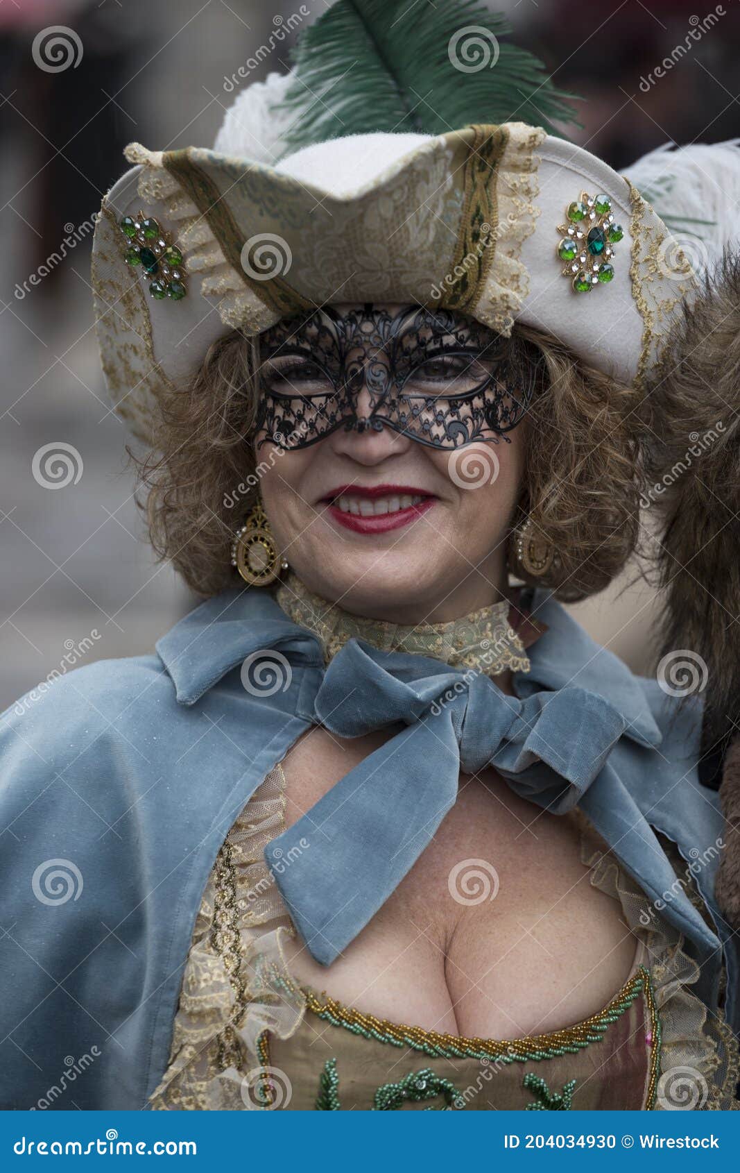 A female in a beautiful dress and traditional Venice mask during the world-famous carnival