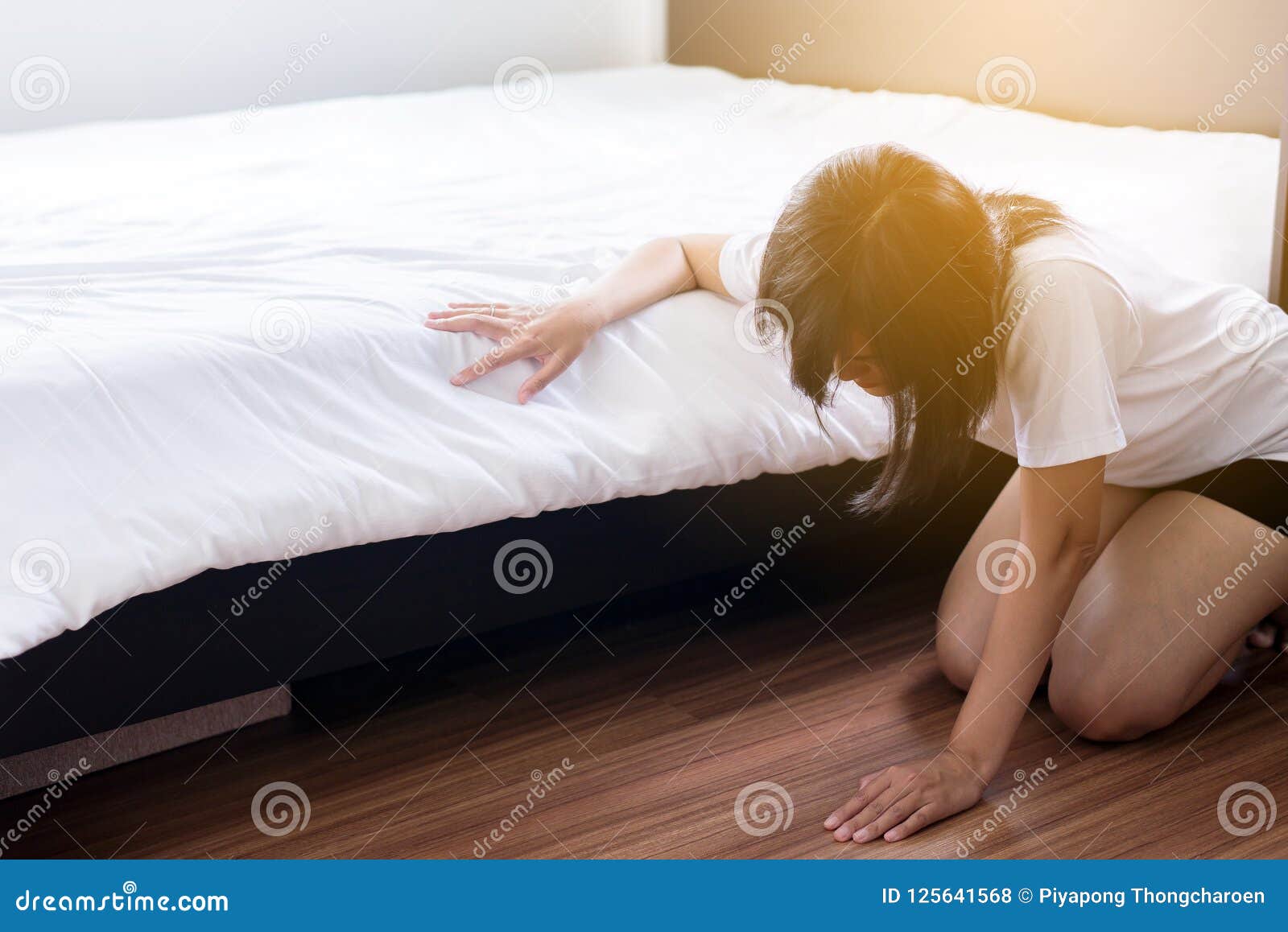 woman bent and searching something under bed lost thing