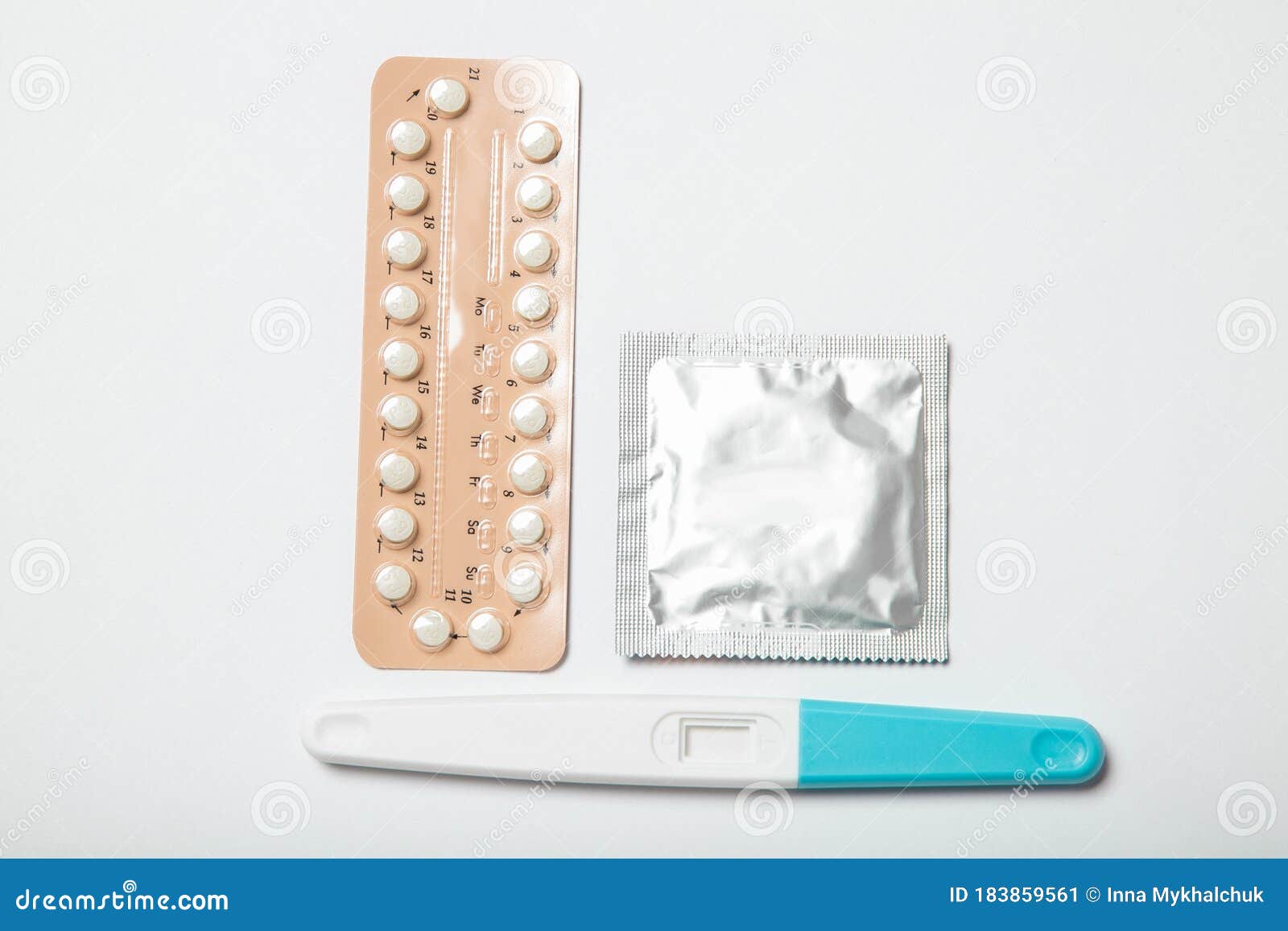 Female Birth Control Pills Pregnancy Test And Condom On A White