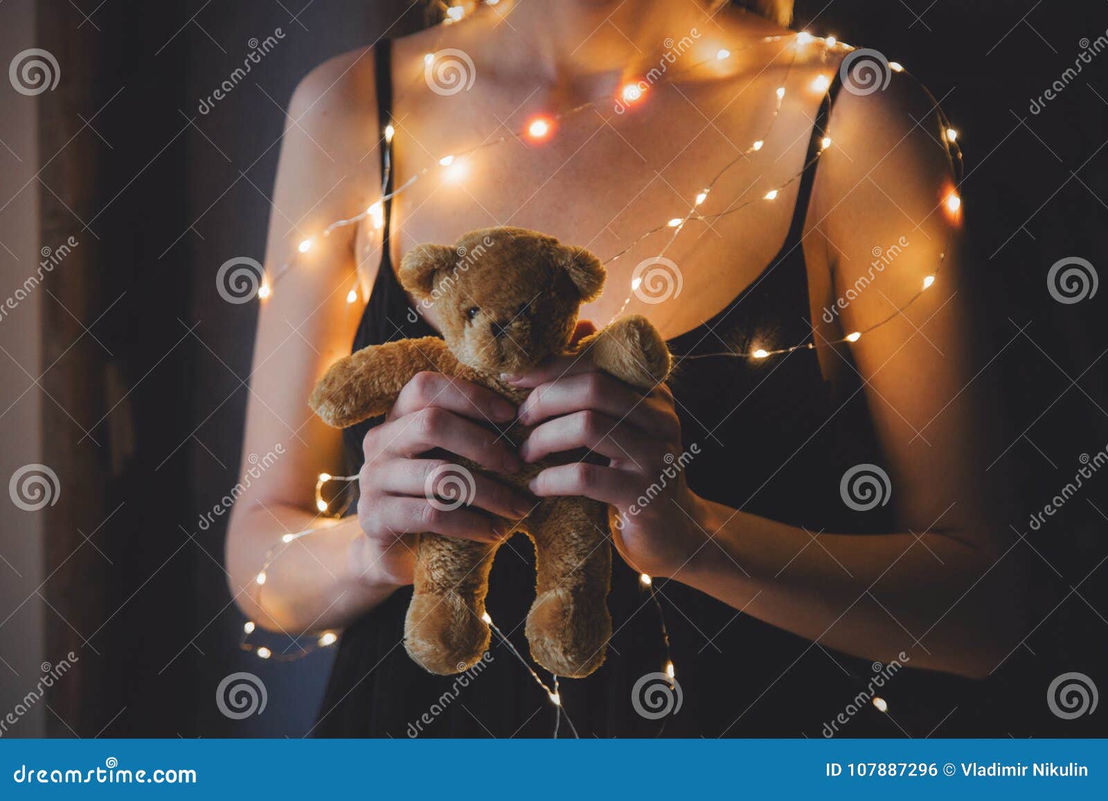 Female in Black Dress and Lights Holding Teddy Bear Toy Stock Photo ...