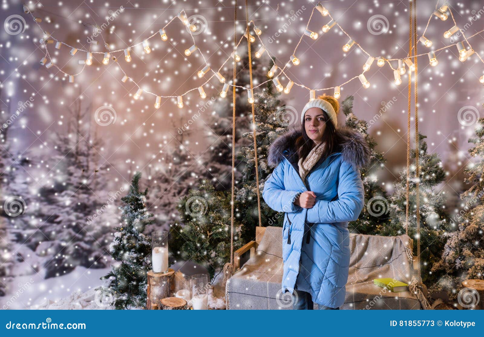 Female in Blue Down Jacket Standing Near Bench or a Swing with a Stock ...