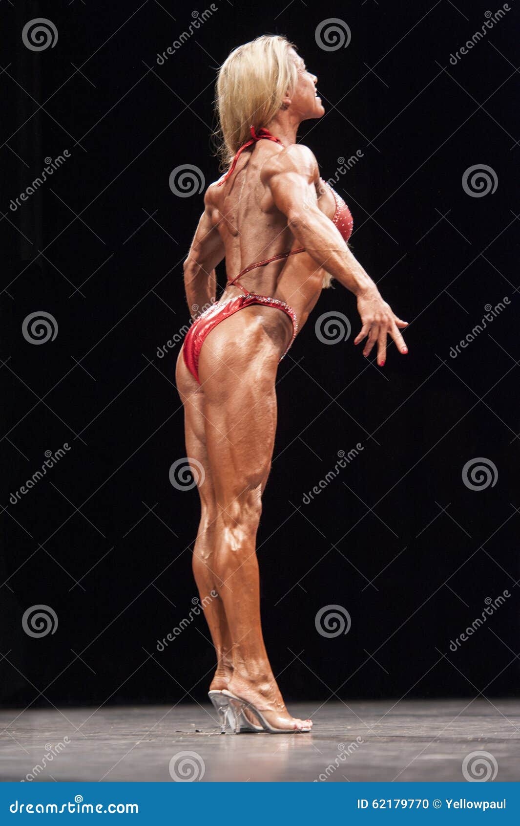 Bodybuilder flexing back and biceps. Muscular athlete posing on stage. Top  sportsmen at bodybuilding competition. Opponents are watching. Stock Photo  | Adobe Stock