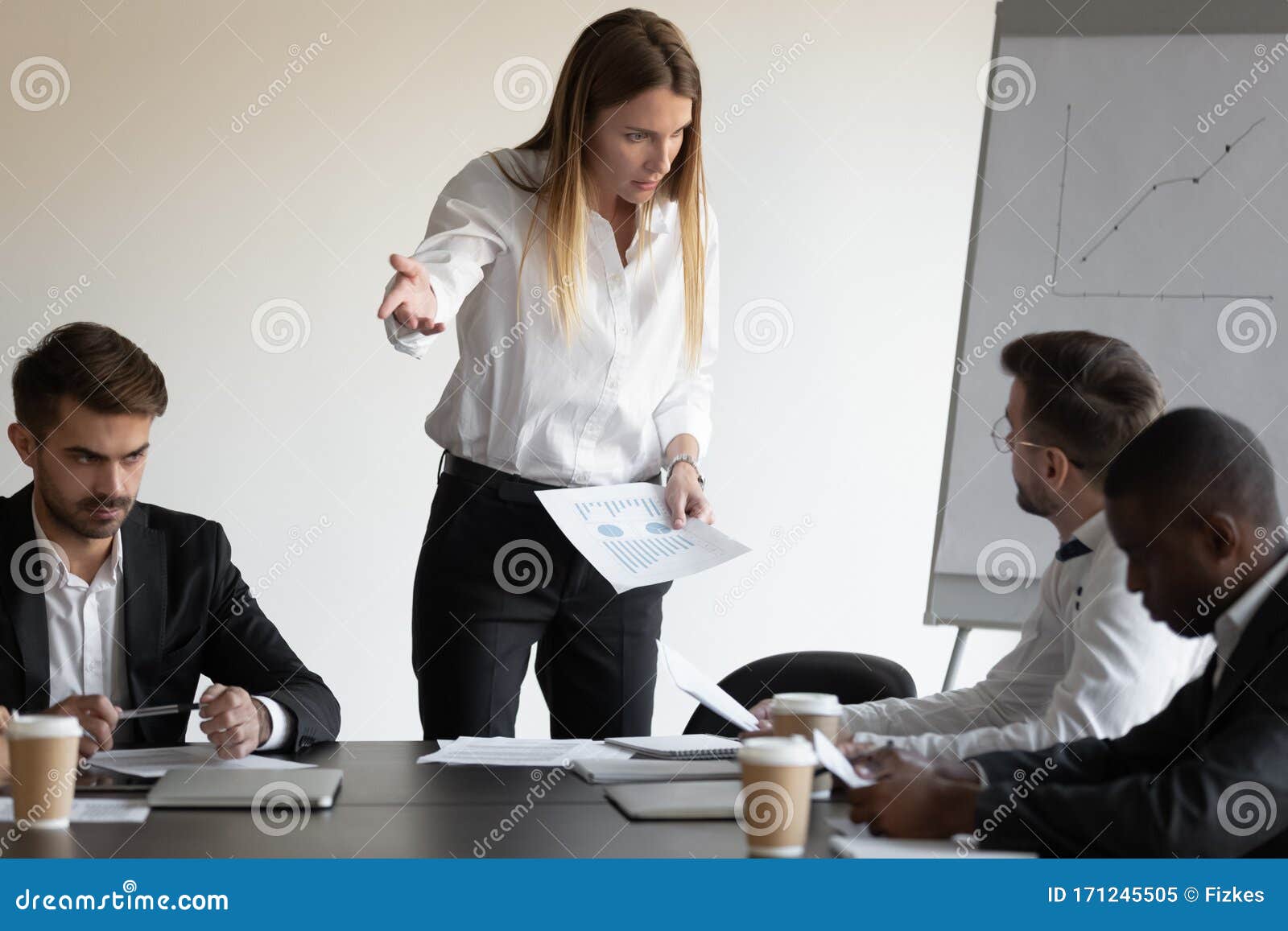 female boss and employee having conflict during meeting in boardroom