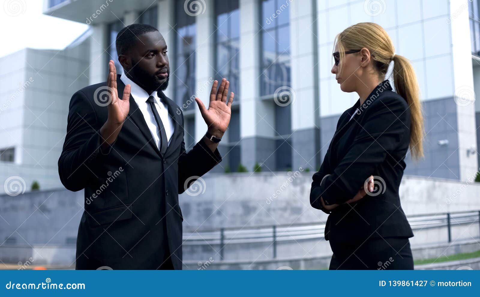 female boss offending afro-american employee, man trying to justify his doings