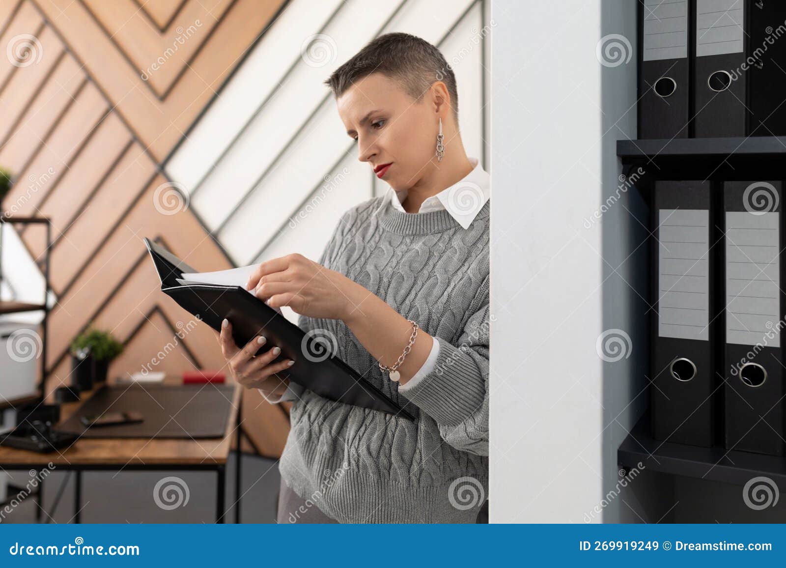 Female Boss in the Office with Documents Against the Wall Stock Image