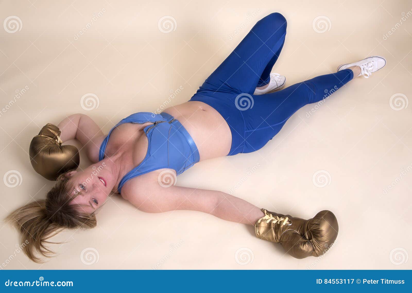 Pretty Female Boxer Knocked Out Laying On The Floor Stock Photo